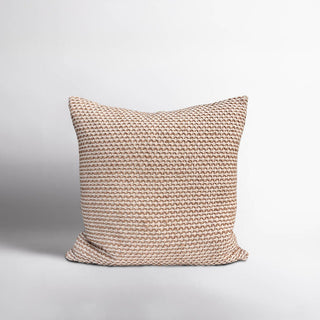 Textured beige pillow on a light gray background