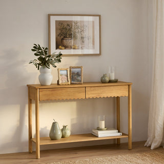 Wooden console table with decorative items in a room setting