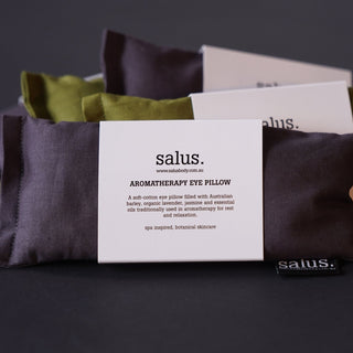 Aromatherapy eye pillow with a salus branded card on a dark background
