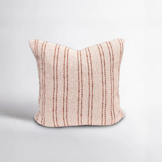 Striped pillow with red and beige pattern on a light gray background