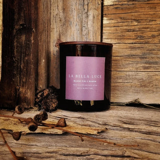 Candle with a purple label on a wooden surface