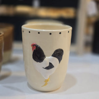 Ceramic cup with a chicken design on a blurred background