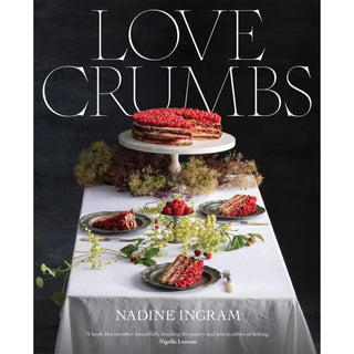 Book cover of 'Love Crumbs' by Nadine Ingram with a cake and dessert setup on a table.