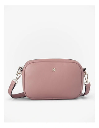 Pink crossbody bag on a light gray background