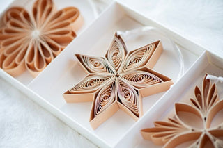 Decorative paper stars in a white box on a white background