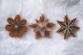 Three paper stars ornaments on a white background