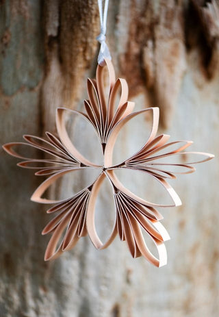 Decorative paper star hanging against a wooden background