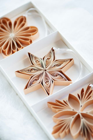 Decorative paper star in a white box on a light background