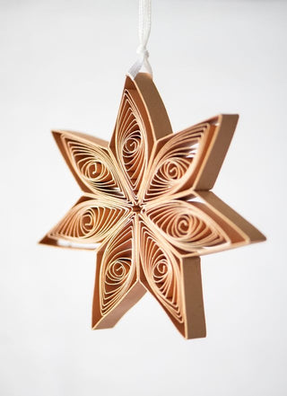 Decorative star-shaped ornament with intricate patterns on a white background