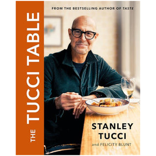 Book cover of 'The Tucci Table' featuring a man eating at a table with a glass of wine.