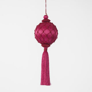 Pink decorative lantern with tassel on a white background