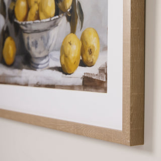 Framed artwork of lemons on a still life composition.