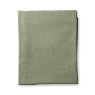 Folded green fabric on a white background