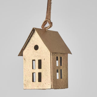 Gold house-shaped pendant on a gray background