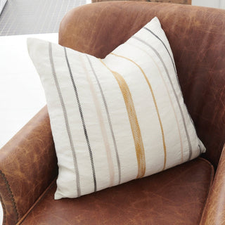 Striped pillow on a brown leather armchair