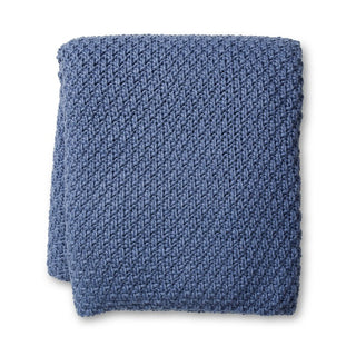 Blue knitted blanket on a white background