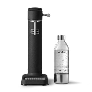 Black aarke sparkling water dispenser with a silver bottle on a white background
