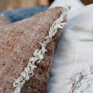 Close-up of textured pillows with a focus on the lace trim.