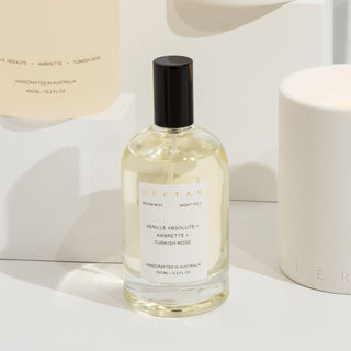 Bottle of Kenta perfume with a white label on a light background