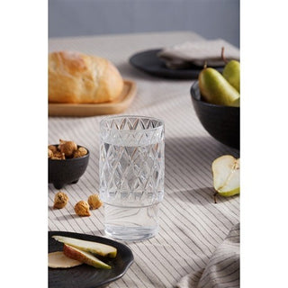 Clear glass with geometric pattern on a table with bread and pears