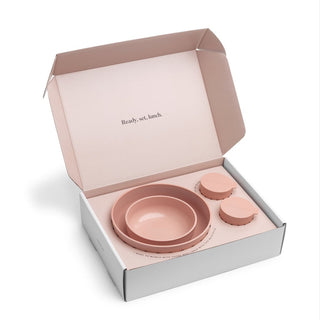 Pink ceramic bowls set in a box with 'Ready, set, lunch.' text.