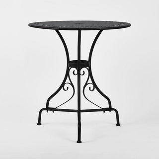 Black metal table with decorative legs on a white background