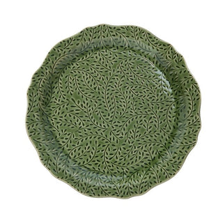 Green ceramic plate with leaf pattern on a white background