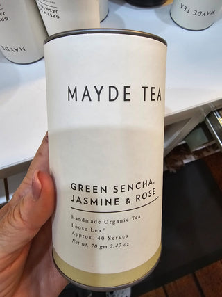 Mayde Tea canister with Green Sencha, Jasmine & Rose flavor held by a hand.