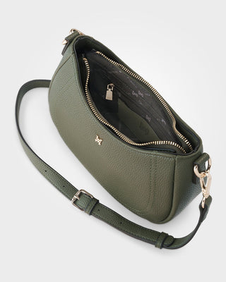 Green leather handbag with a strap on a white background