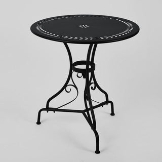 Black metal table with decorative design on a light gray background