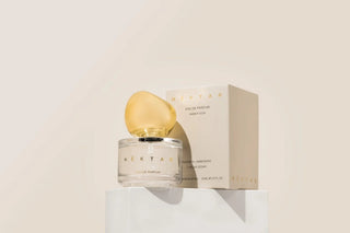 Perfume bottle and packaging on a light beige background