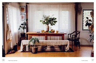 Living room with wooden table, chairs, and decorative plants.