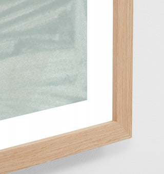 Close-up of a wooden picture frame with glass on a white background