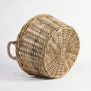 Woven basket with handles on a light gray background