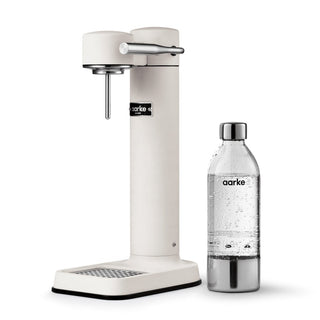 Aarke sparkling water machine and bottle on a white background