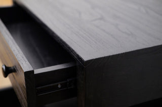 Close-up of a black wooden drawer being pulled out