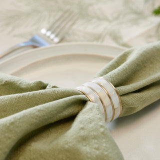 Green napkin with a decorative ring on a table setting