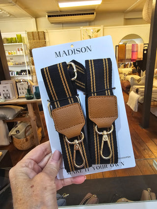 Crossbody Bag Straps on a Madison brand card held by a hand in a store setting.