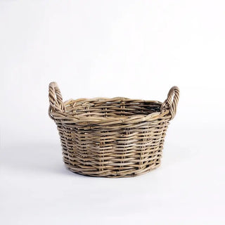 Wicker basket with handles on a white background