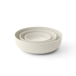 Set of three beige bowls of different sizes on a white background