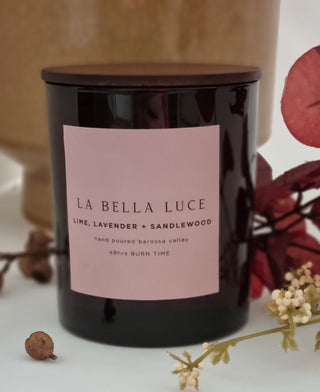 Black candle with a pink label featuring 'La Bella Luce' on a neutral background.