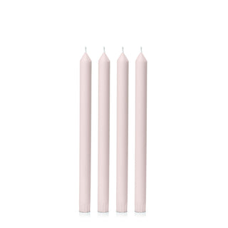 Five pink candles of varying lengths on a white background