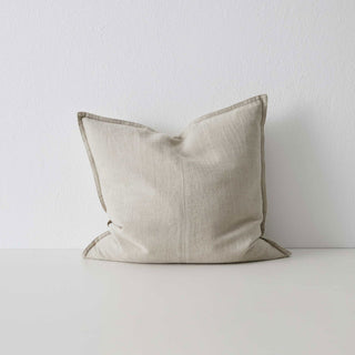 Beige pillow on a white surface with a light gray background