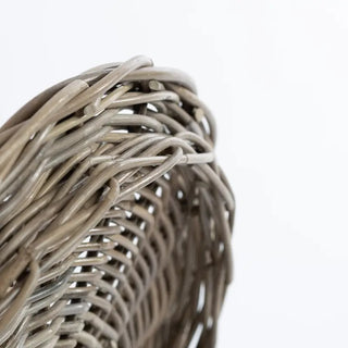 Close-up of a woven basket with a plain background