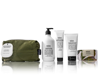 Set of skincare products with a green travel pouch on a white background