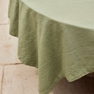 Green fabric draped over a surface with a neutral background