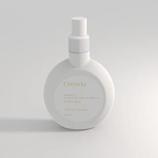 White bottle of Orenda Aroma Mist on a light gray background
