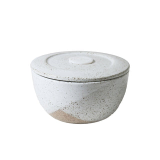 Speckled ceramic bowl with lid on a white background