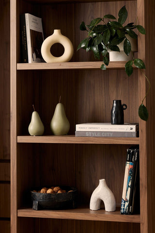 Wooden bookshelf with decorative items including books, vases, and a plant.
