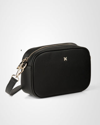 Black crossbody bag with gold accents on a white background
